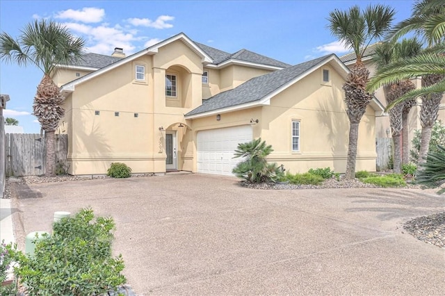 403 Marina Dr, Port Aransas, TX 78373 - traditional-style home featuring stucco siding, driveway, a garage, and a shingled roof