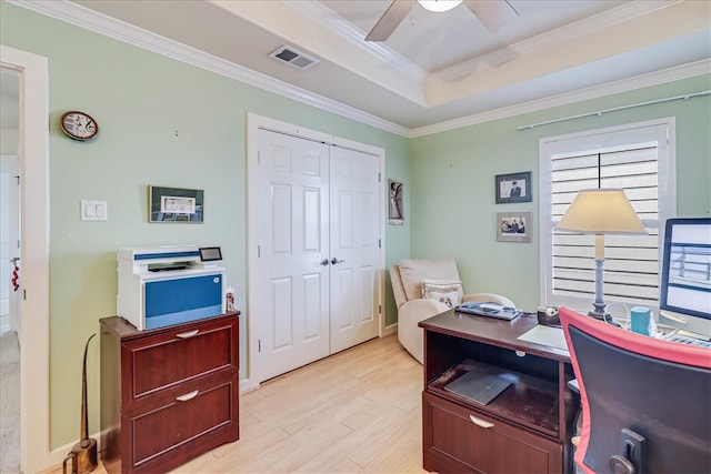 office area with light wood-type flooring, ceiling fan, and crown molding