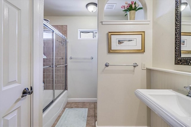 403 Marina Dr, Port Aransas, TX 78373 - full bath with a sink, bath / shower combo with glass door, tile patterned flooring, and baseboards