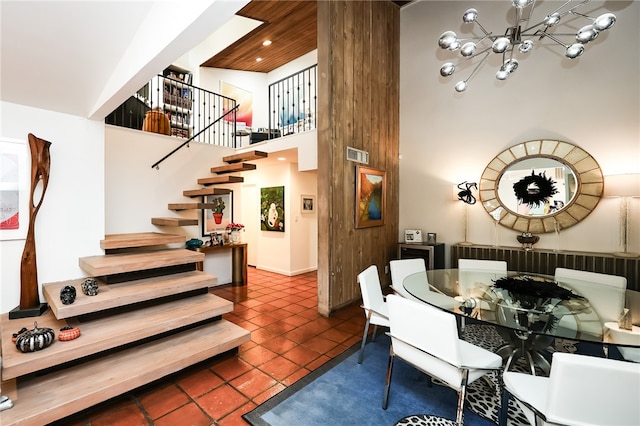 tiled dining room with a notable chandelier and a towering ceiling