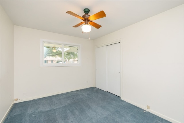 unfurnished bedroom featuring a closet, dark colored carpet, and ceiling fan