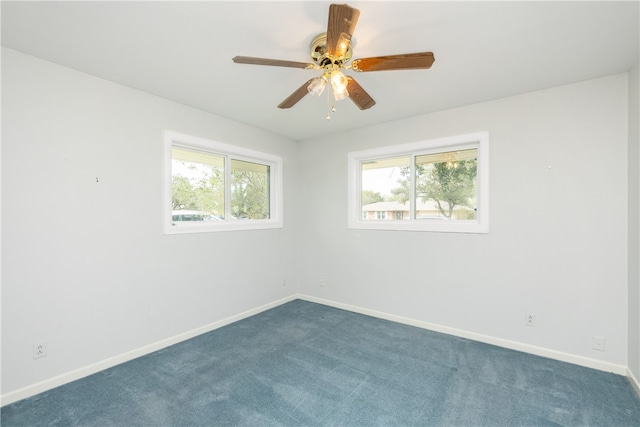 carpeted empty room featuring ceiling fan