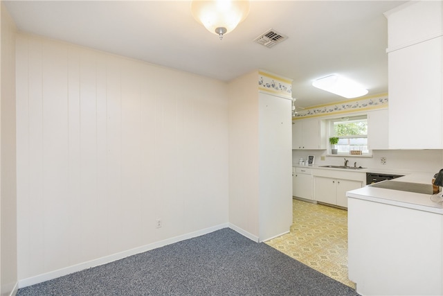 kitchen featuring white cabinets and sink