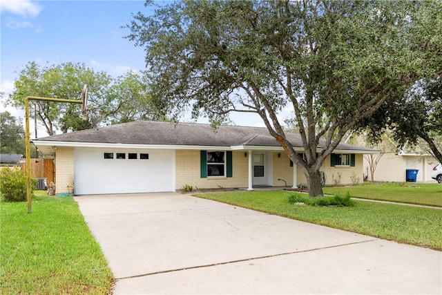 ranch-style house with central AC unit, a front yard, and a garage