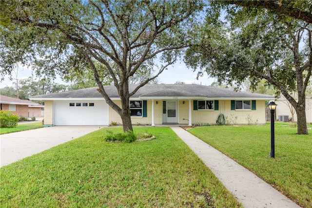 ranch-style house with central AC unit, a front yard, and a garage