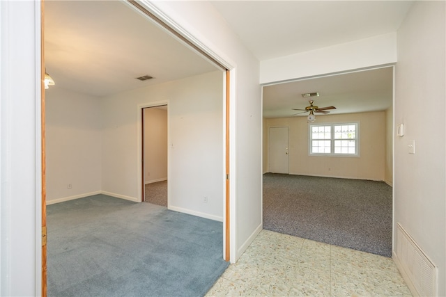 spare room featuring light colored carpet and ceiling fan