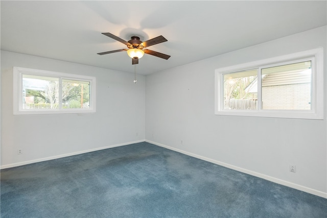 unfurnished room featuring ceiling fan and dark carpet