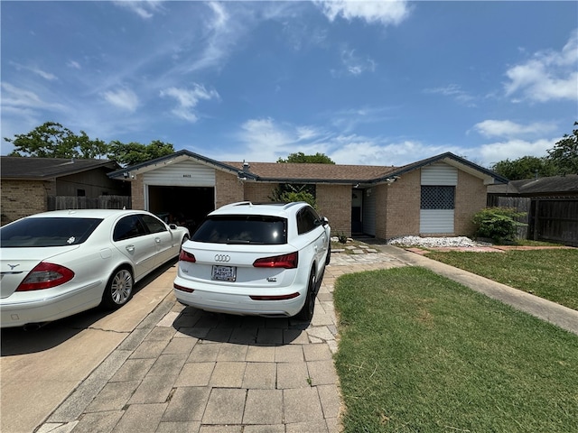 view of front of home featuring a garage, a front yard, and brick siding