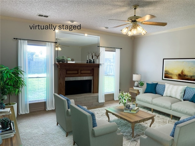 living room with crown molding, a textured ceiling, and a brick fireplace