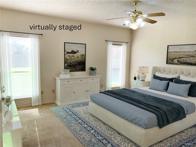 bedroom with multiple windows, a textured ceiling, and ceiling fan