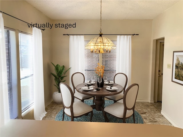 dining space with baseboards, a chandelier, and a textured ceiling