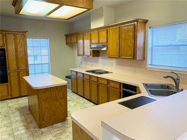 kitchen featuring sink, stainless steel gas cooktop, and a kitchen island