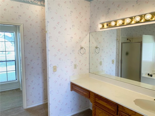 bathroom with walk in shower, a wealth of natural light, and vanity