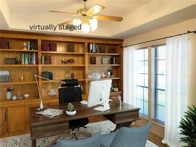 home office featuring a textured ceiling and ceiling fan