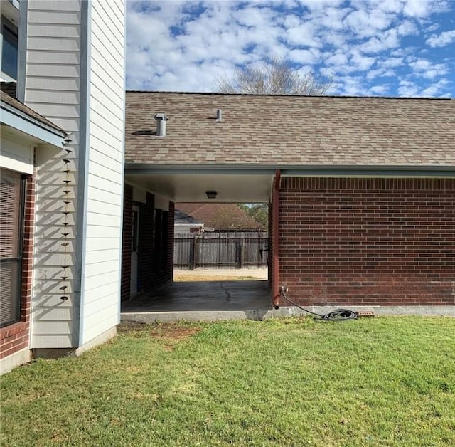 view of property exterior with a carport and a lawn