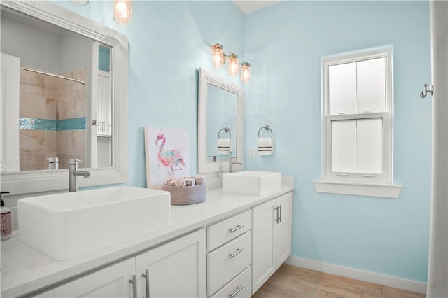 bathroom with vanity, hardwood / wood-style floors, and walk in shower