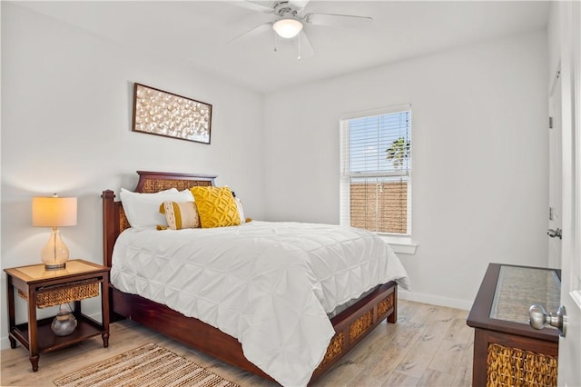 bedroom with light hardwood / wood-style floors and ceiling fan