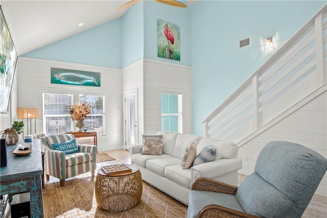 living room with ceiling fan, plenty of natural light, and high vaulted ceiling