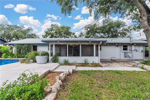 single story home featuring a patio and a sunroom