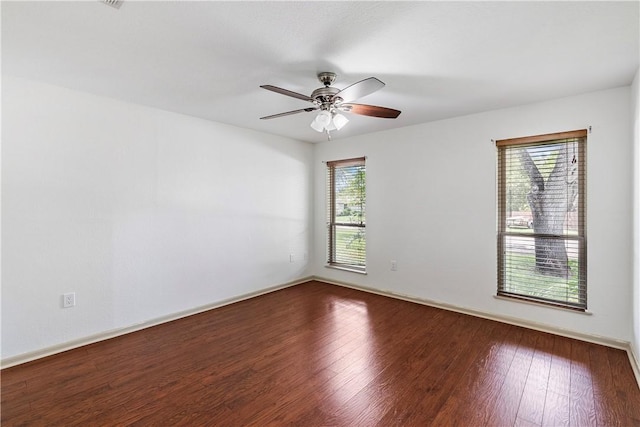 empty room with hardwood / wood-style floors and ceiling fan