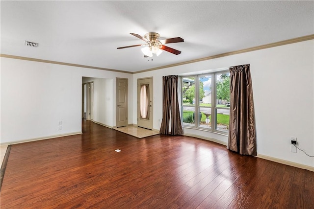 empty room featuring dark hardwood / wood-style floors, ceiling fan, and ornamental molding