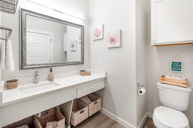 bathroom with vanity, hardwood / wood-style flooring, and toilet