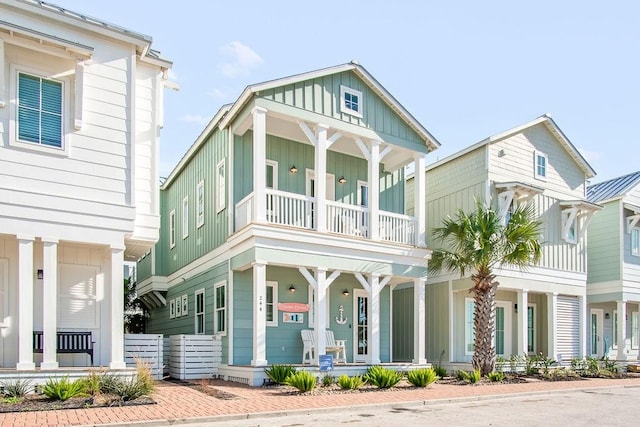 view of front facade featuring a balcony, a porch, and board and batten siding