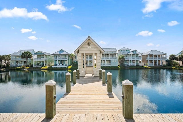 view of dock featuring a water view and a residential view