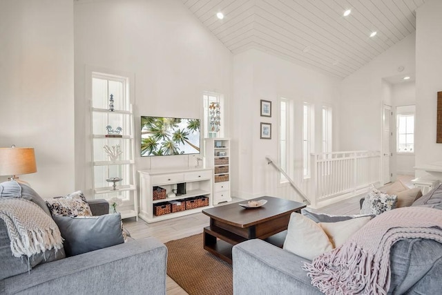 living area with high vaulted ceiling, light wood finished floors, wooden ceiling, and recessed lighting