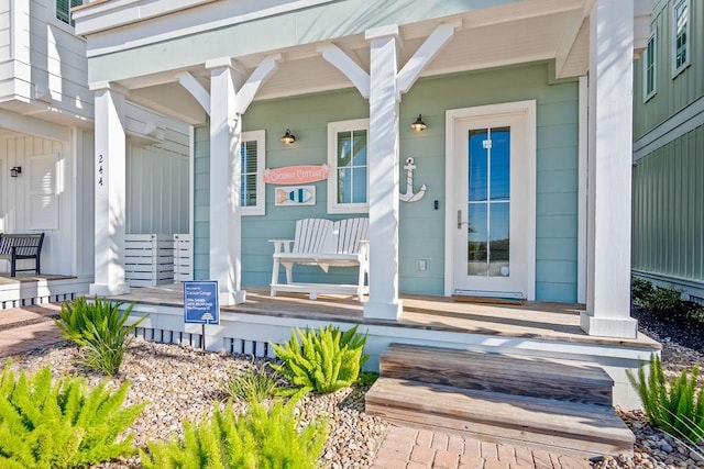 view of exterior entry with covered porch