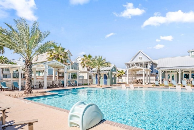 community pool with fence, a pergola, and a patio