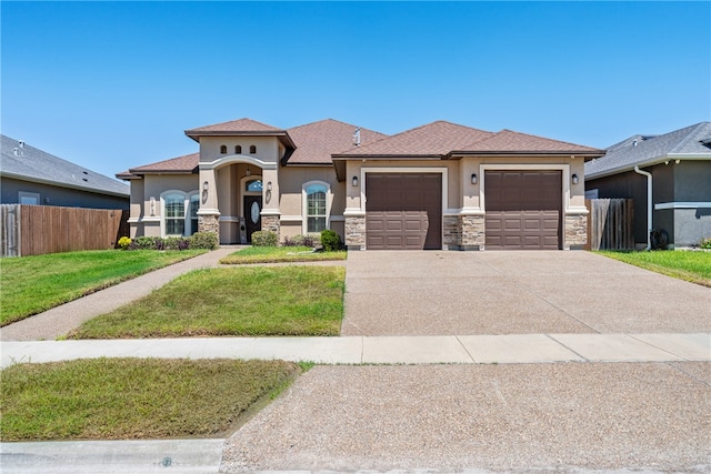 view of front facade with a garage and a front lawn