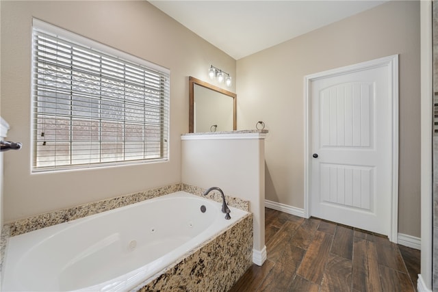 bathroom with hardwood / wood-style floors and a tub