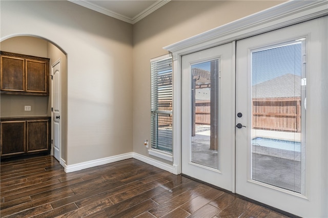 entryway with french doors, dark wood-type flooring, and crown molding