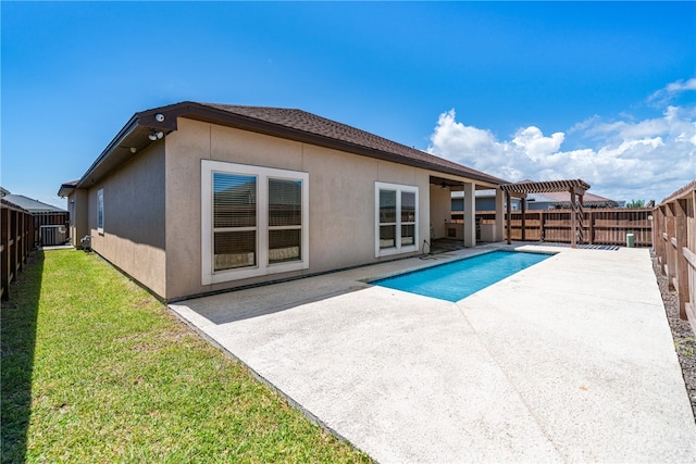 view of swimming pool featuring a lawn, central air condition unit, and a patio area