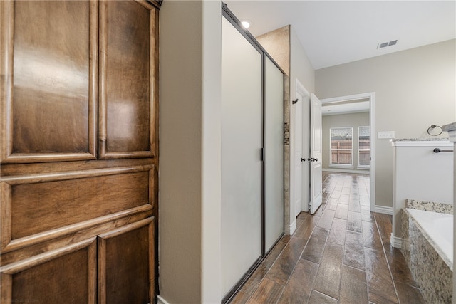 hall with dark wood-type flooring