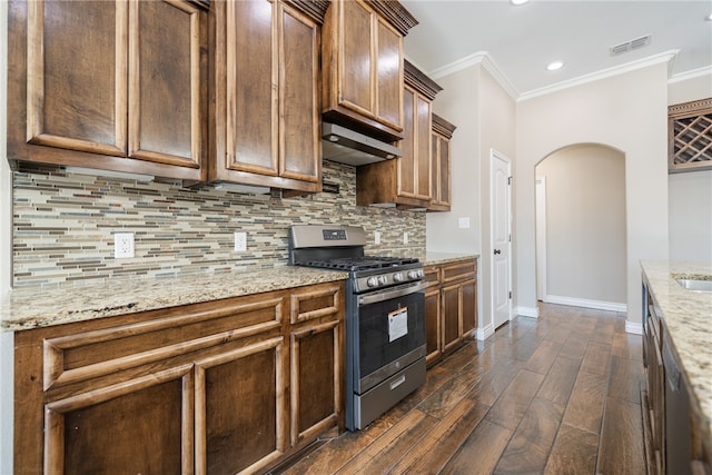 kitchen with exhaust hood, dark hardwood / wood-style floors, light stone counters, and gas stove