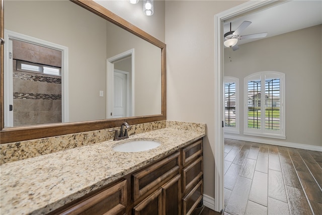 bathroom with vanity, hardwood / wood-style flooring, and ceiling fan