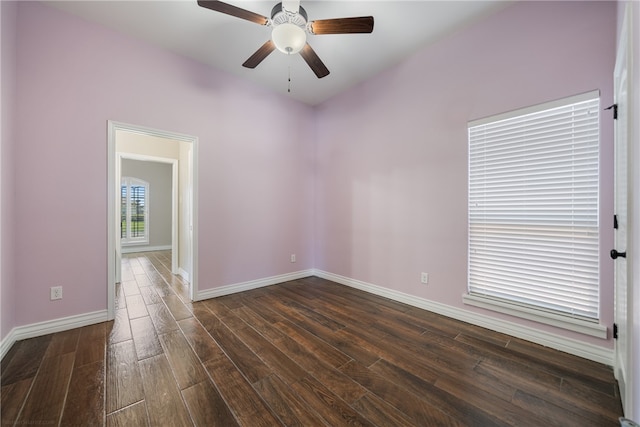 spare room with dark wood-type flooring and ceiling fan