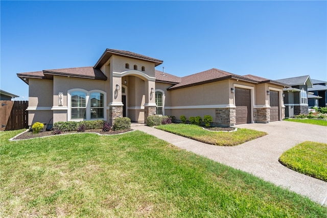 view of front of property featuring a front yard and a garage