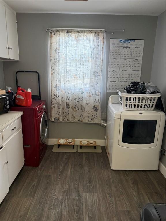 2802 Devon Dr, Corpus Christi, TX 78404 - laundry area featuring cabinet space, dark wood finished floors, and washing machine and dryer