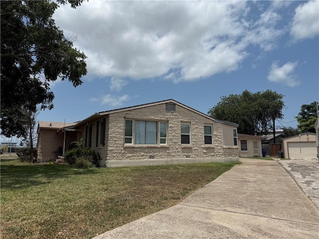 2802 Devon Dr, Corpus Christi, TX 78404 - ranch-style home featuring driveway, a front yard, stone siding, a detached garage, and an outdoor structure