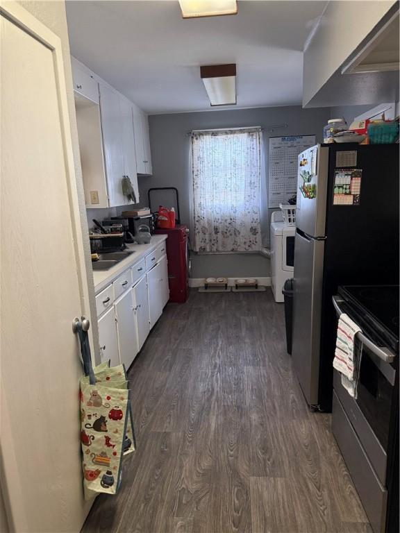2802 Devon Dr, Corpus Christi, TX 78404 - kitchen with stainless steel electric range oven, dark wood-style flooring, white cabinetry, light countertops, and washer / clothes dryer