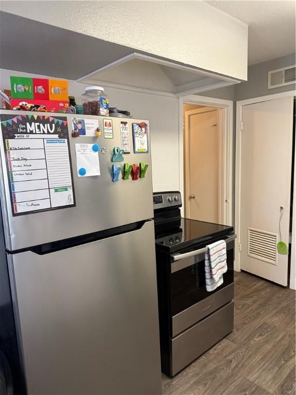 2802 Devon Dr, Corpus Christi, TX 78404 - kitchen featuring appliances with stainless steel finishes, wood finished floors, and a textured ceiling