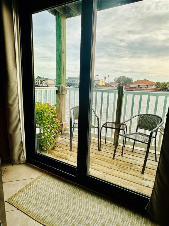 interior space with tile patterned flooring, a healthy amount of sunlight, and a water view