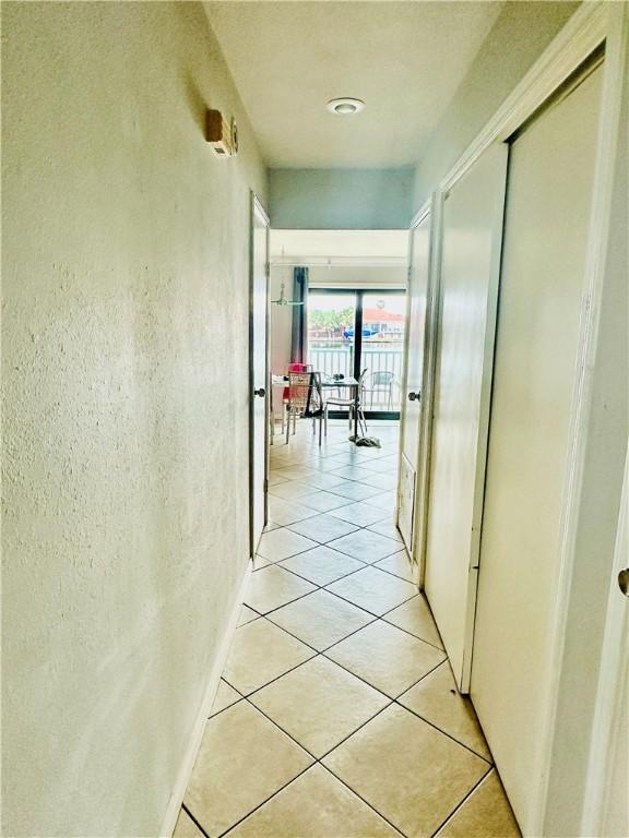 corridor featuring light tile patterned flooring