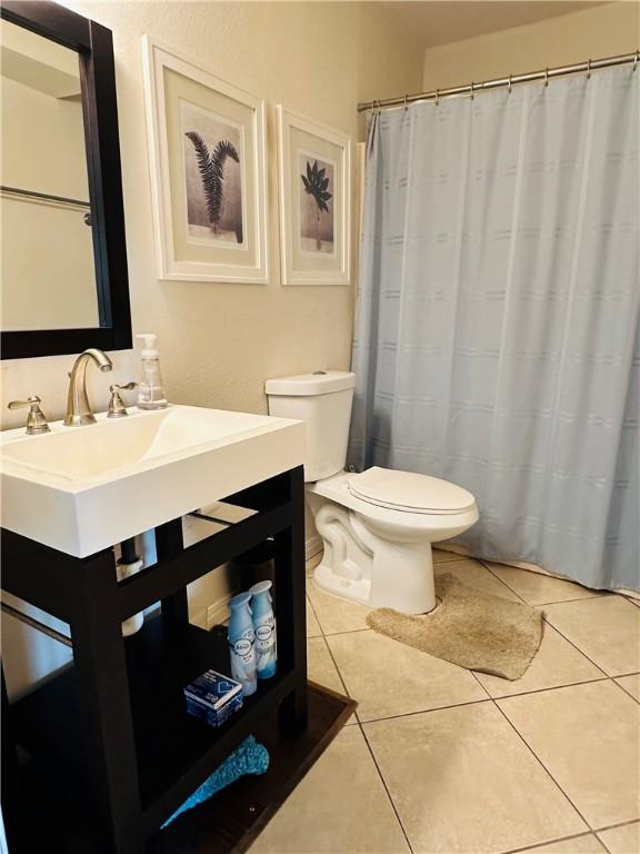 bathroom with toilet and tile patterned floors