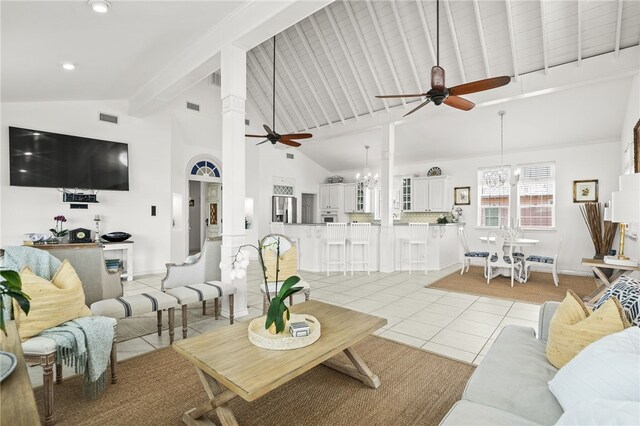 4820 Sanibel Ln, Port Aransas, TX 78373 - living area featuring beam ceiling, light tile patterned floors, high vaulted ceiling, visible vents, and ceiling fan with notable chandelier