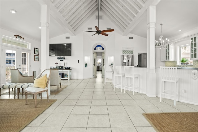 4820 Sanibel Ln, Port Aransas, TX 78373 - living area with light tile patterned floors, visible vents, high vaulted ceiling, and ceiling fan with notable chandelier