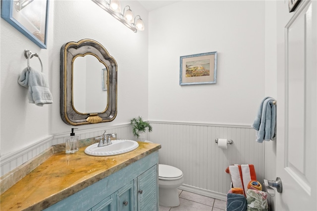 4820 Sanibel Ln, Port Aransas, TX 78373 - half bath with tile patterned floors, vanity, toilet, and a wainscoted wall